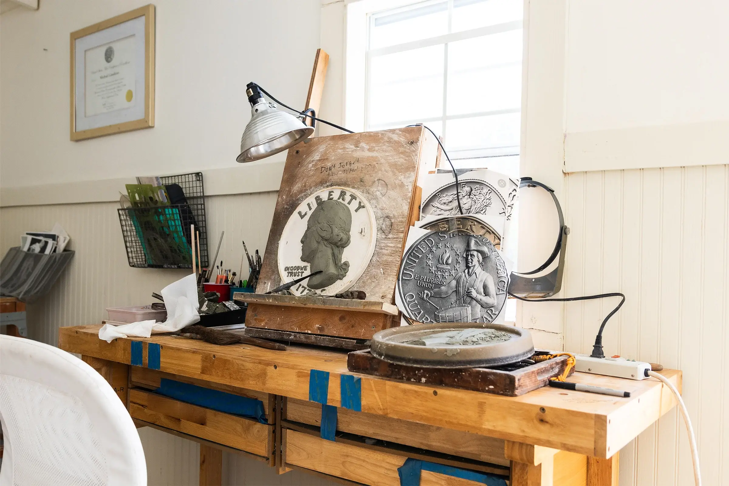 Wide view of Michael Gaudioso's studio workbench and Bicentennial Quarter sculpting materials